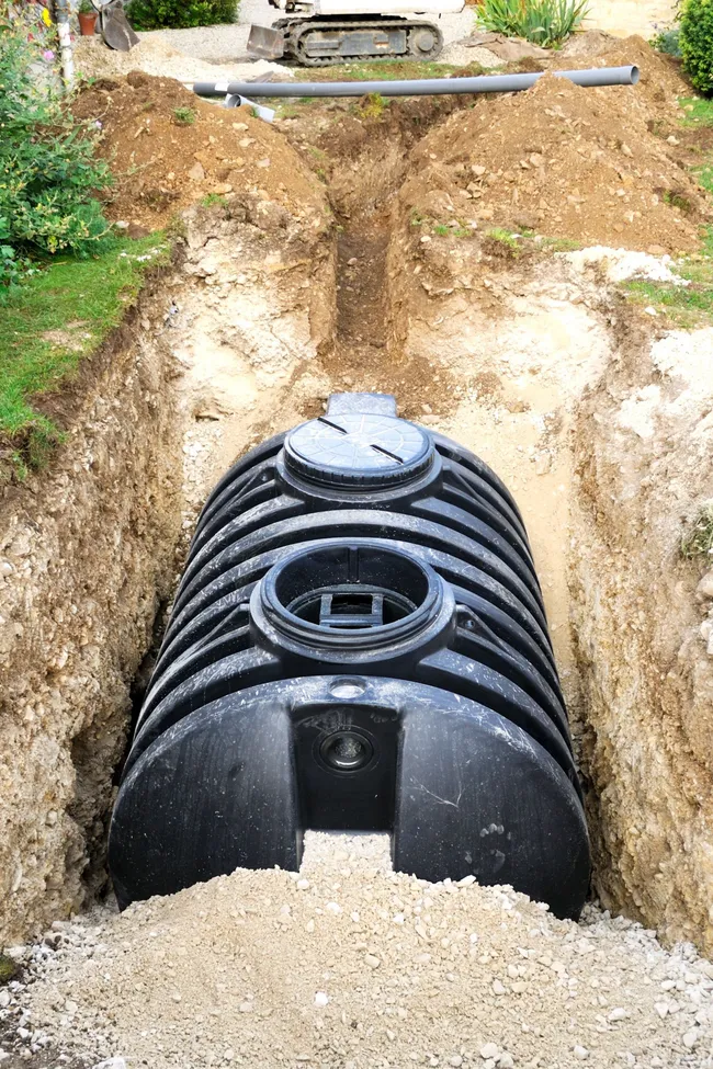Black water tank being installed in a trench. Black water tank being installed in a trench.